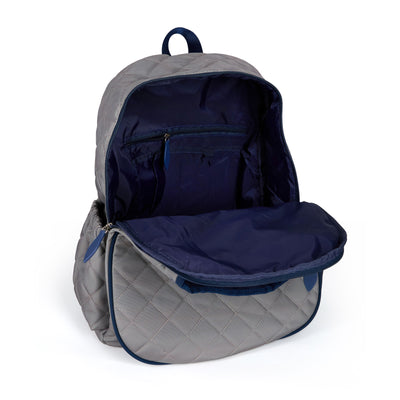 Women's tennis backpack with quilted grey nylon fabric and navy trim. The front pocket is holding a tennis racquet.