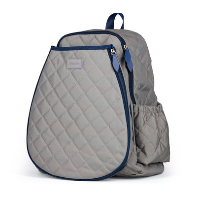 Women's tennis backpack with quilted grey nylon fabric and navy trim. The front pocket is holding a tennis racquet.