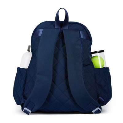 Women's tennis backpack with navy quilted nylon fabric and white trim. There is a tennis racquet in the front pocket.