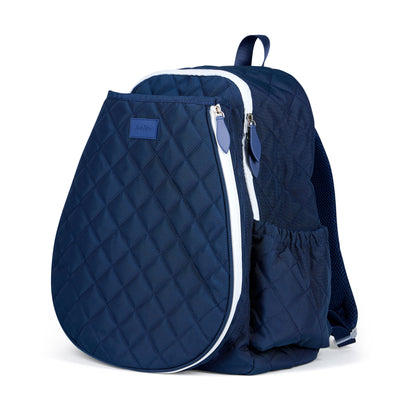 Women's tennis backpack with navy quilted nylon fabric and white trim. There is a tennis racquet in the front pocket.