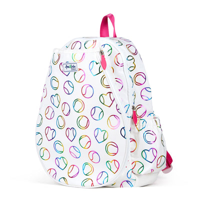 White kids tennis backpack with hot pink zippers and metallic rainbow tennis balls and hearts printed on the fabric.