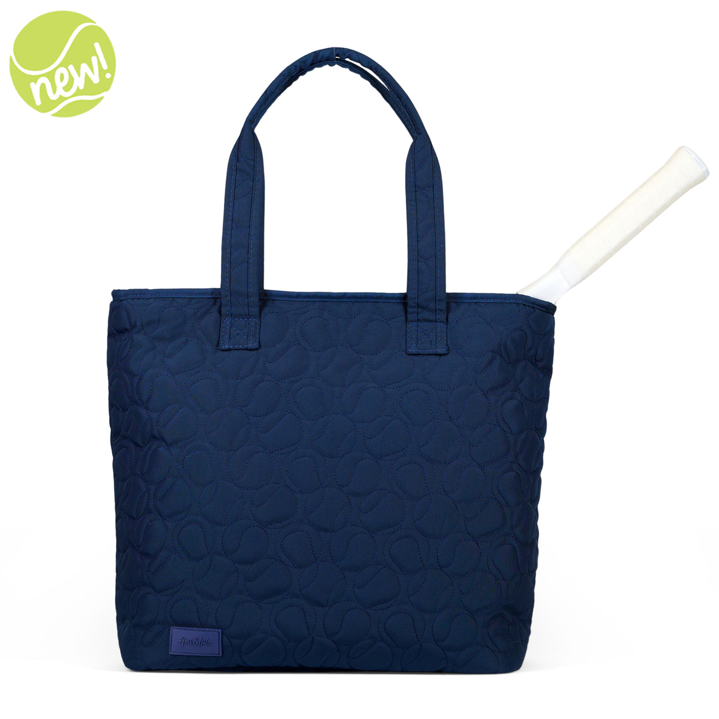 Navy nylon tennis tote with tennis ball quilted pattern.