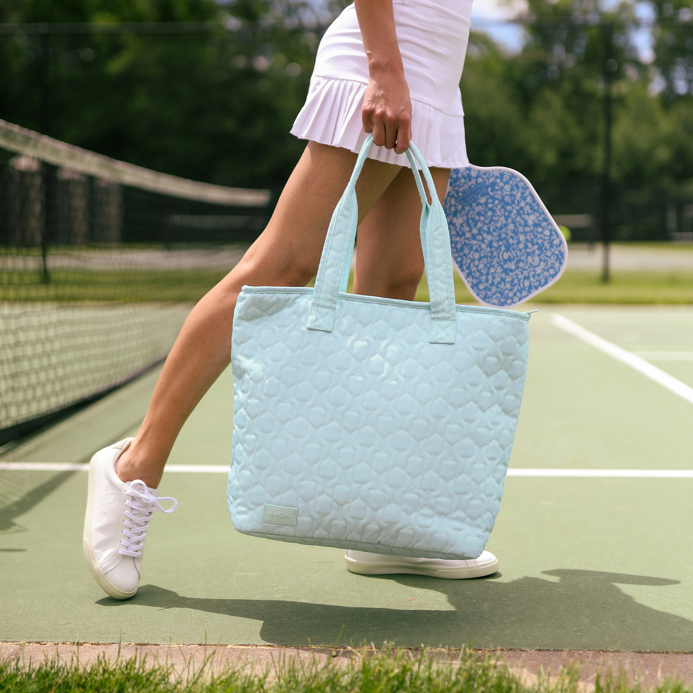 Light blue nylon pickleball tote with pickleball paddle quilted pattern.