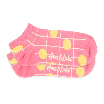 Pair of womens short socks in coral color with cream grid lines and yellow tennis balls stitched on them