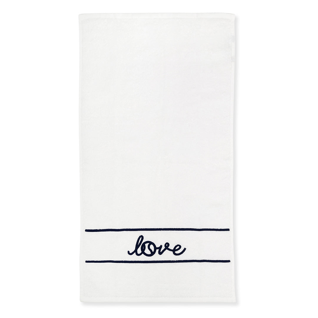 White terry towel laying flat on white background with navy stripes and the word love embroidered on it